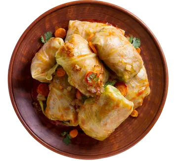 Sarme na drvenom tanjiru sa šargarepom i peršunom.